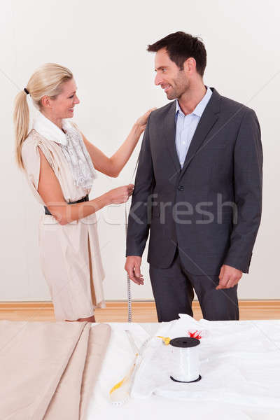 Seamstress measuring a man for a suit Stock photo © AndreyPopov