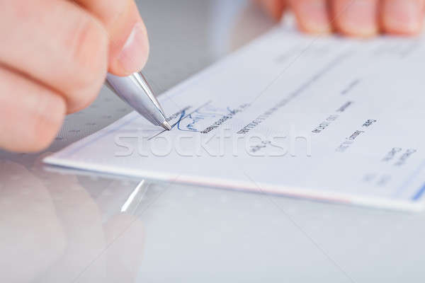 Mão caneta talão de cheques escrita Foto stock © AndreyPopov