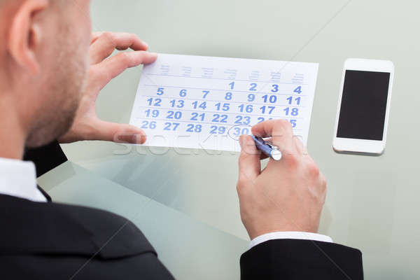 Empresario lácteo calendario reuniones teléfono móvil mentiras Foto stock © AndreyPopov