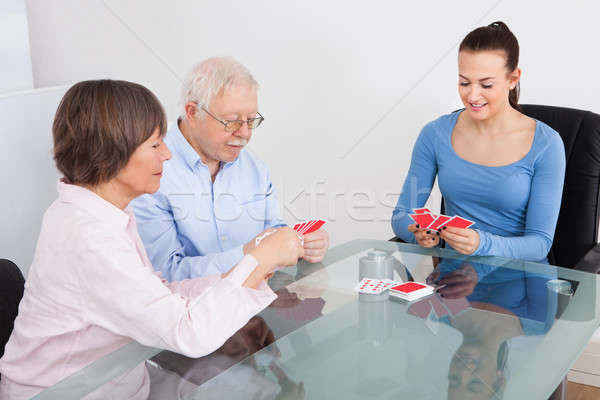 Caretaker Playing Cards With Senior Couple Stock photo © AndreyPopov