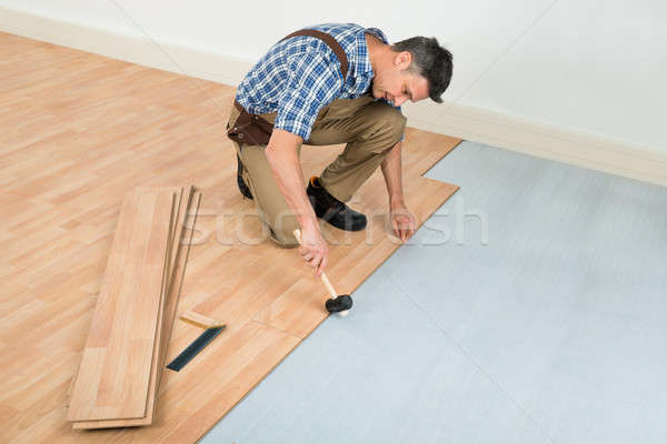 Man Installing New Laminated Wooden Floor Stock photo © AndreyPopov