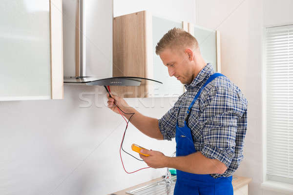 Worker Testing Kitchen Hood With Multimeter Stock photo © AndreyPopov