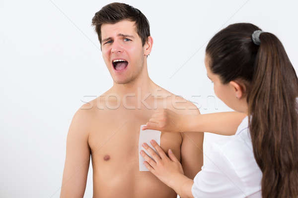 Beautician Waxing Man's Chest In Beauty Center Stock photo © AndreyPopov