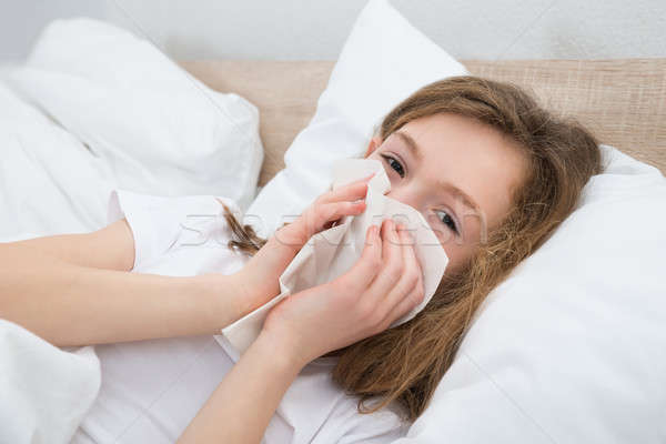 Lány zsebkendő beteg ágy hálószoba arc Stock fotó © AndreyPopov