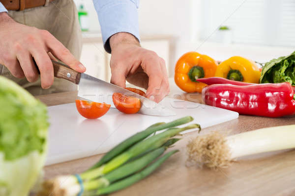 Male Hands Cutting Tomato At Countertop Stock photo © AndreyPopov