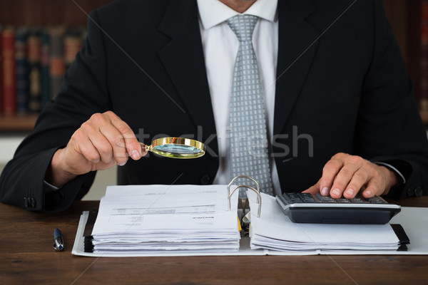 Accountant Scrutinizing Financial Documents In Office Stock photo © AndreyPopov