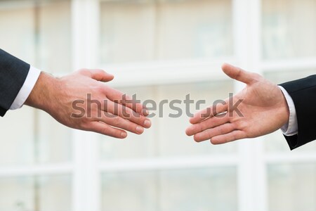 Businessman Showing Middle Finger To Partner Offering Handshake Stock photo © AndreyPopov