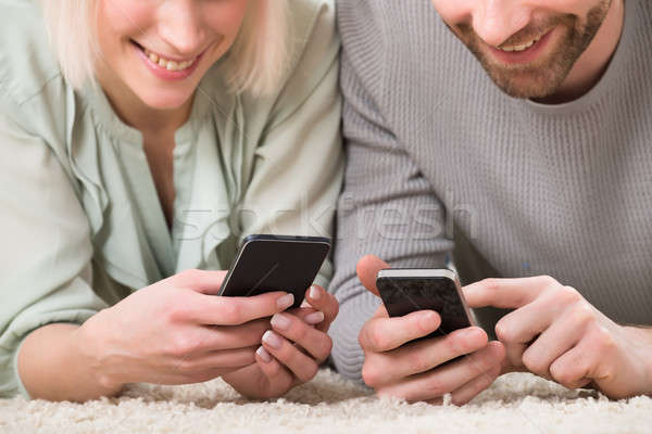 Close-up Of Couple Holding Cellphones Stock photo © AndreyPopov