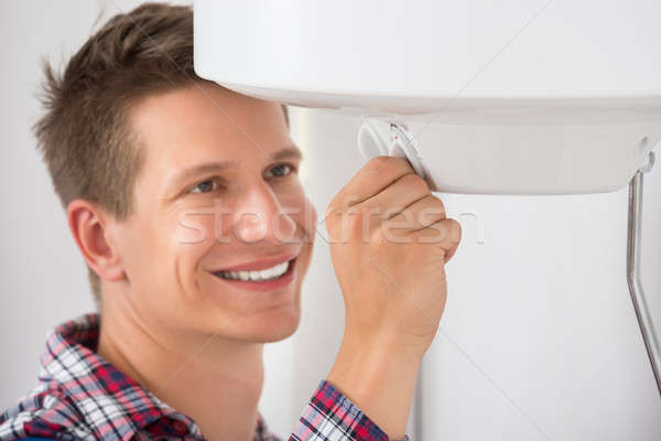 Plumber Adjusting Temperature Of Electric Boiler Stock photo © AndreyPopov