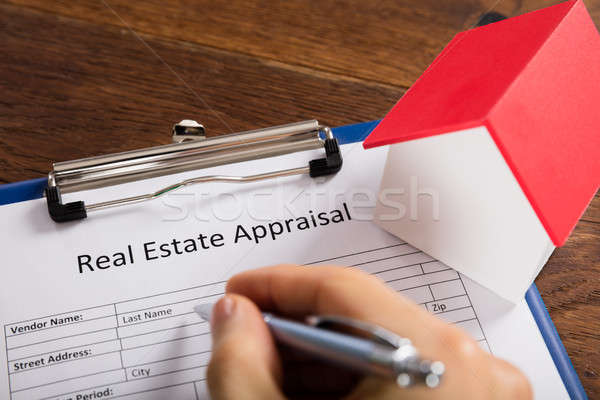 Person Filling Real Estate Appraisal Form At Desk Stock photo © AndreyPopov