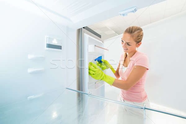 Smiling Woman Cleaning Inside The Refrigerator Stock photo © AndreyPopov