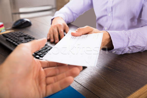 Businessman Giving Cheque To Her Colleague Stock photo © AndreyPopov