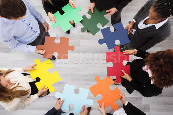 Business People Holding Colorful Jigsaw Puzzles Stock photo © AndreyPopov