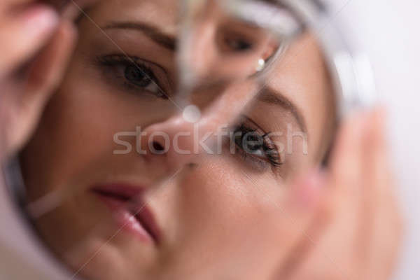 Woman's Face In Broken Mirror Stock photo © AndreyPopov