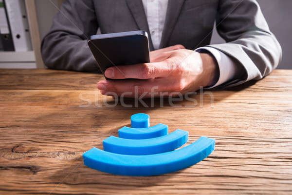 Businessperson's Hand Using Mobile Phone Stock photo © AndreyPopov