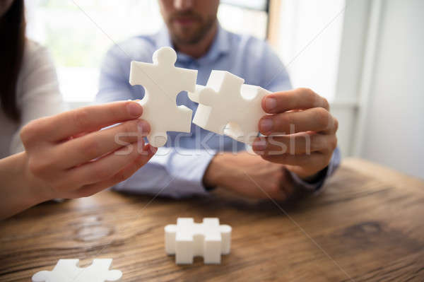 Stock photo: Two Businesspeople Connecting Jigsaw Pieces