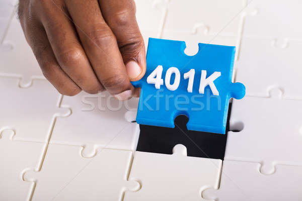 Hand Holding 401k Jigsaw Puzzle Stock photo © AndreyPopov