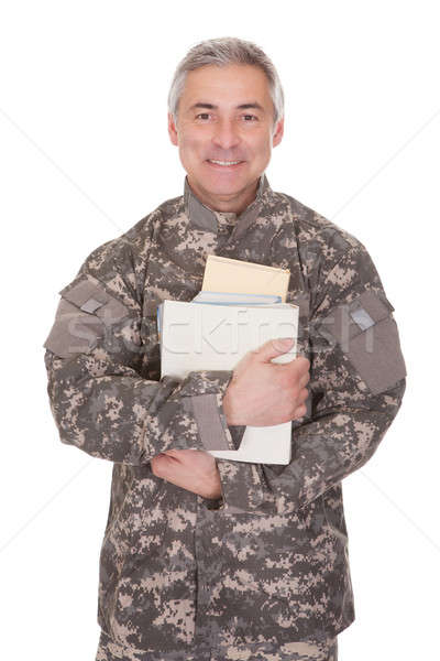 Mature Soldier Holding Stack Of Books Stock photo © AndreyPopov
