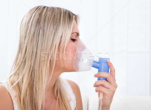 Woman with asthma inhaler Stock photo © AndreyPopov