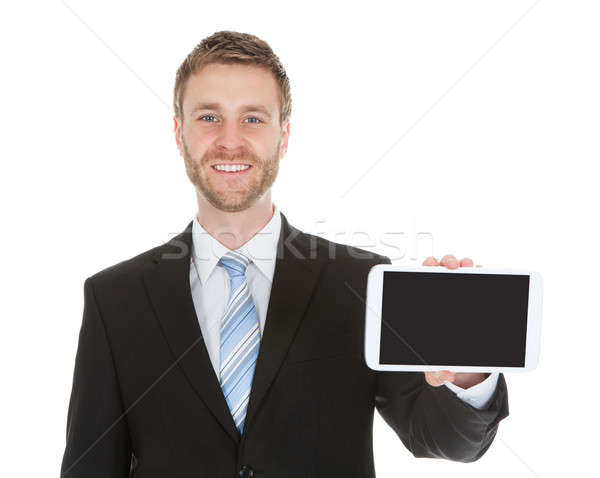 Stock photo: Smiling Businessman Displaying Digital Tablet