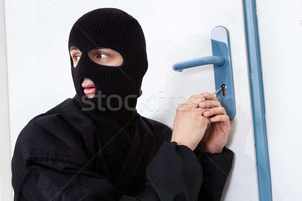 Thief Opening Door With Tool During House Breaking Stock photo © AndreyPopov
