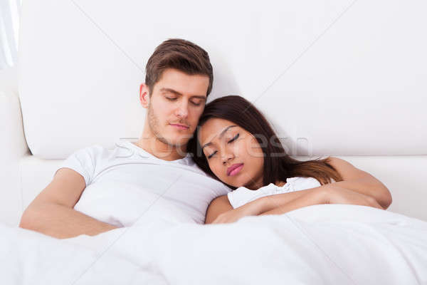Couple dormir matelas affectueux maison Photo stock © AndreyPopov
