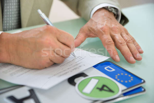 Businessman Filling Car Sale Contract Stock photo © AndreyPopov