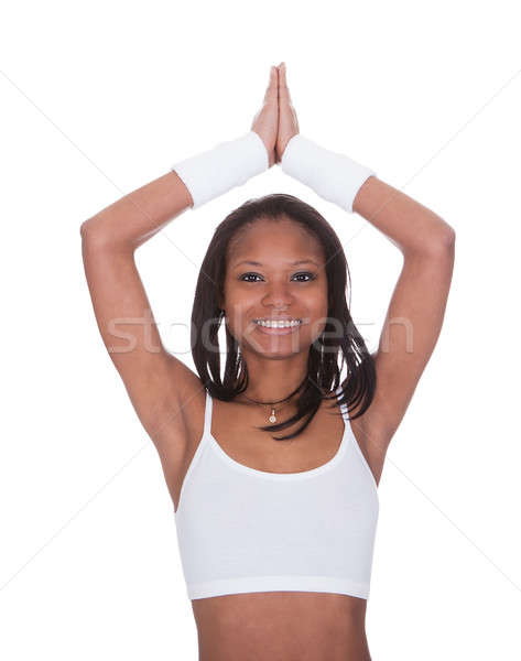 Sporty Woman Performing Yoga Against White Background Stock photo © AndreyPopov