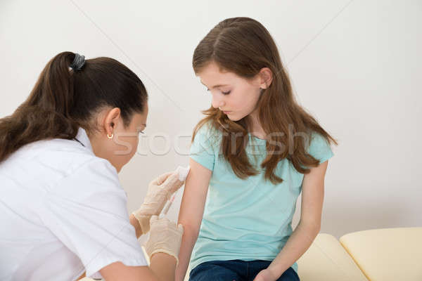 Doctor Injecting Syringe To Patient Stock photo © AndreyPopov