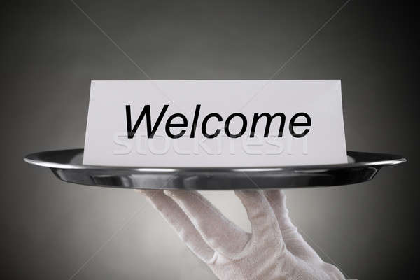 Waiter Holding Plate With Welcome Text On Paper Stock photo © AndreyPopov