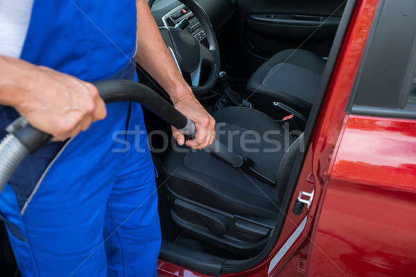 Worker Vacuuming Car With Vacuum Cleaner Stock photo © AndreyPopov