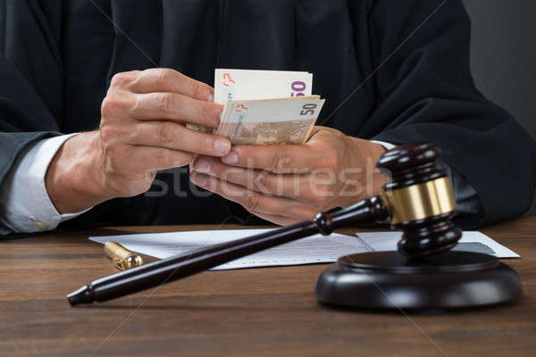 Judge Counting Money At Table Stock photo © AndreyPopov