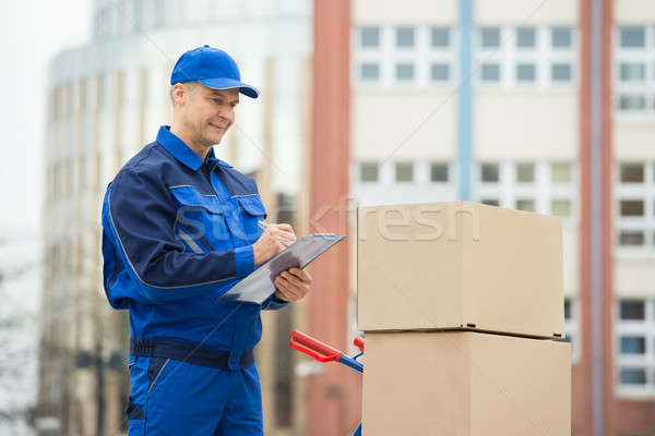Portrait Of Delivery Man With Parcels And Clipboard Stock photo © AndreyPopov