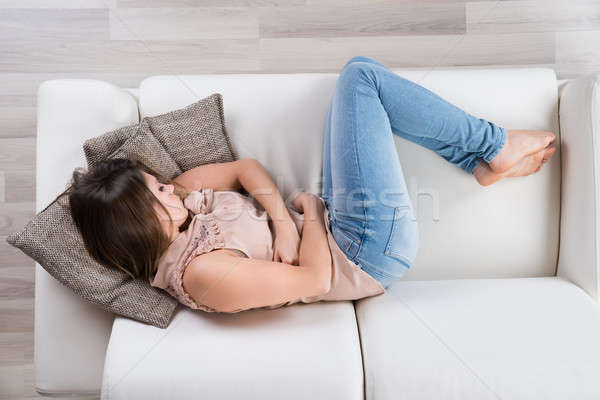 Fiatal nő kanapé magasról fotózva kilátás nő otthon Stock fotó © AndreyPopov