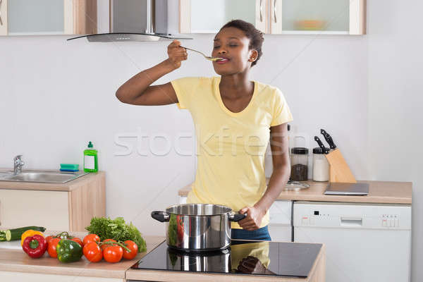 Woman Cooking Meal In Kitchen Stock photo © AndreyPopov