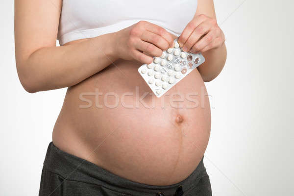 Pregnant Woman Holding Vitamin Pill Stock photo © AndreyPopov
