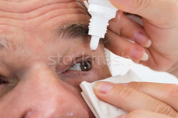 Optometrist Putting Eye Drops In Patient's Eye Stock photo © AndreyPopov