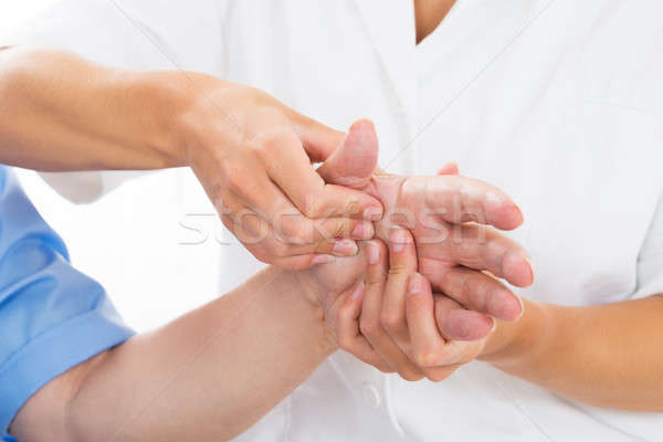 Person Receiving Palm Massage By Physiotherapist Stock photo © AndreyPopov