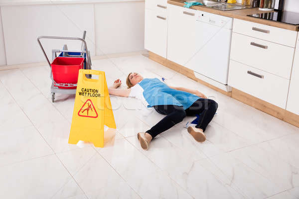 Stock photo: Fainted Housemaid Lying On Floor In Kitchen