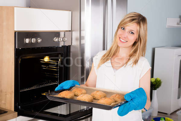 Woman Holding Tray Full Of Cookies Near Oven Stock photo © AndreyPopov