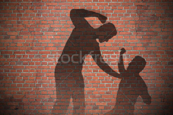 Sombra dos hombres pared de ladrillo mano pared Foto stock © AndreyPopov