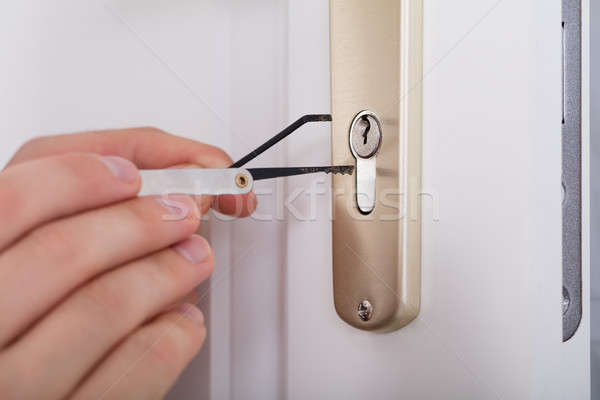 Lockpicker Hand Fixing Door Handle At Home Stock photo © AndreyPopov