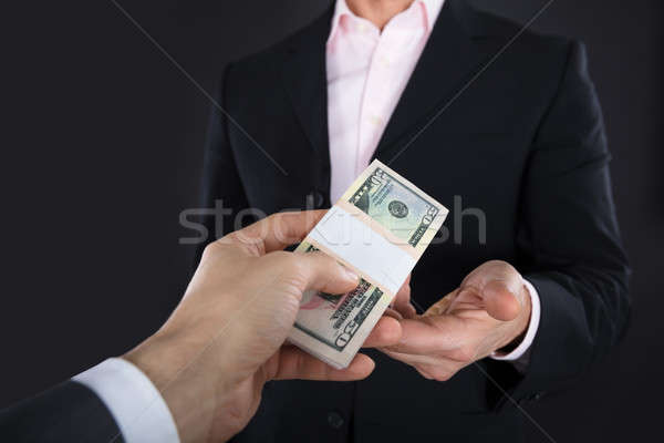 Businessman Receiving A Bank Note Stock photo © AndreyPopov