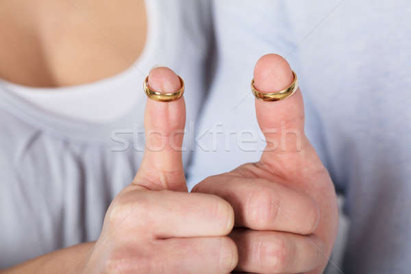 Stock photo: Couple With Gold Rings In Their Thumbs