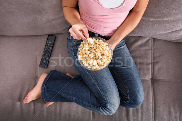 Woman Sitting On Sofa Eating Popcorn Stock photo © AndreyPopov