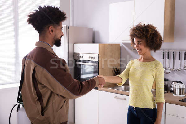 Pest Control Worker Shaking Hands With Woman Stock photo © AndreyPopov