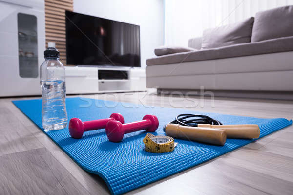 Skipping Rope And Pink Dumbbells On Exercise Mat Stock photo © AndreyPopov
