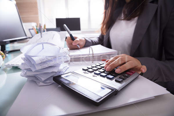 Businesswoman Calculating Invoice Stock photo © AndreyPopov