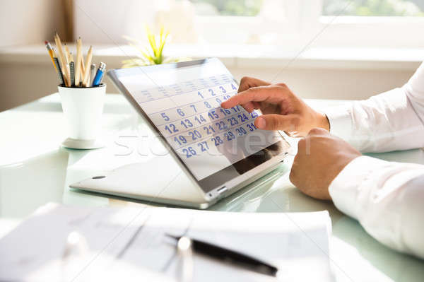 Businessman using calendar on laptop Stock photo © AndreyPopov