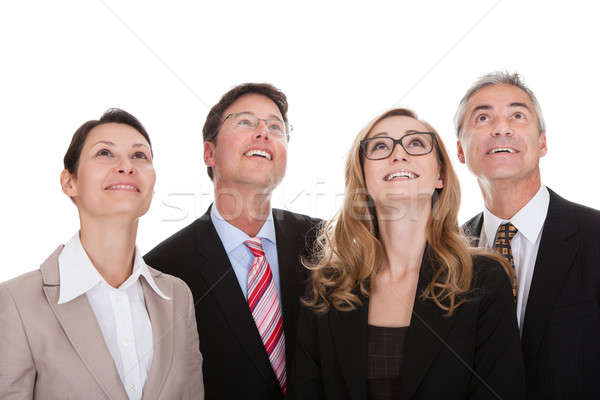 Four happy business partners looking up Stock photo © AndreyPopov